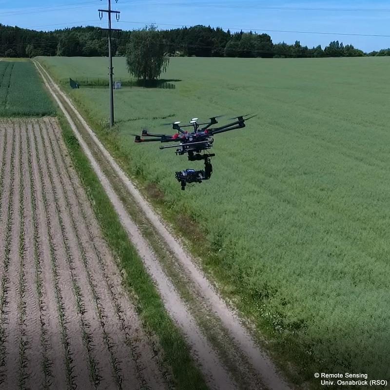 Research drone flying above an agricultural field