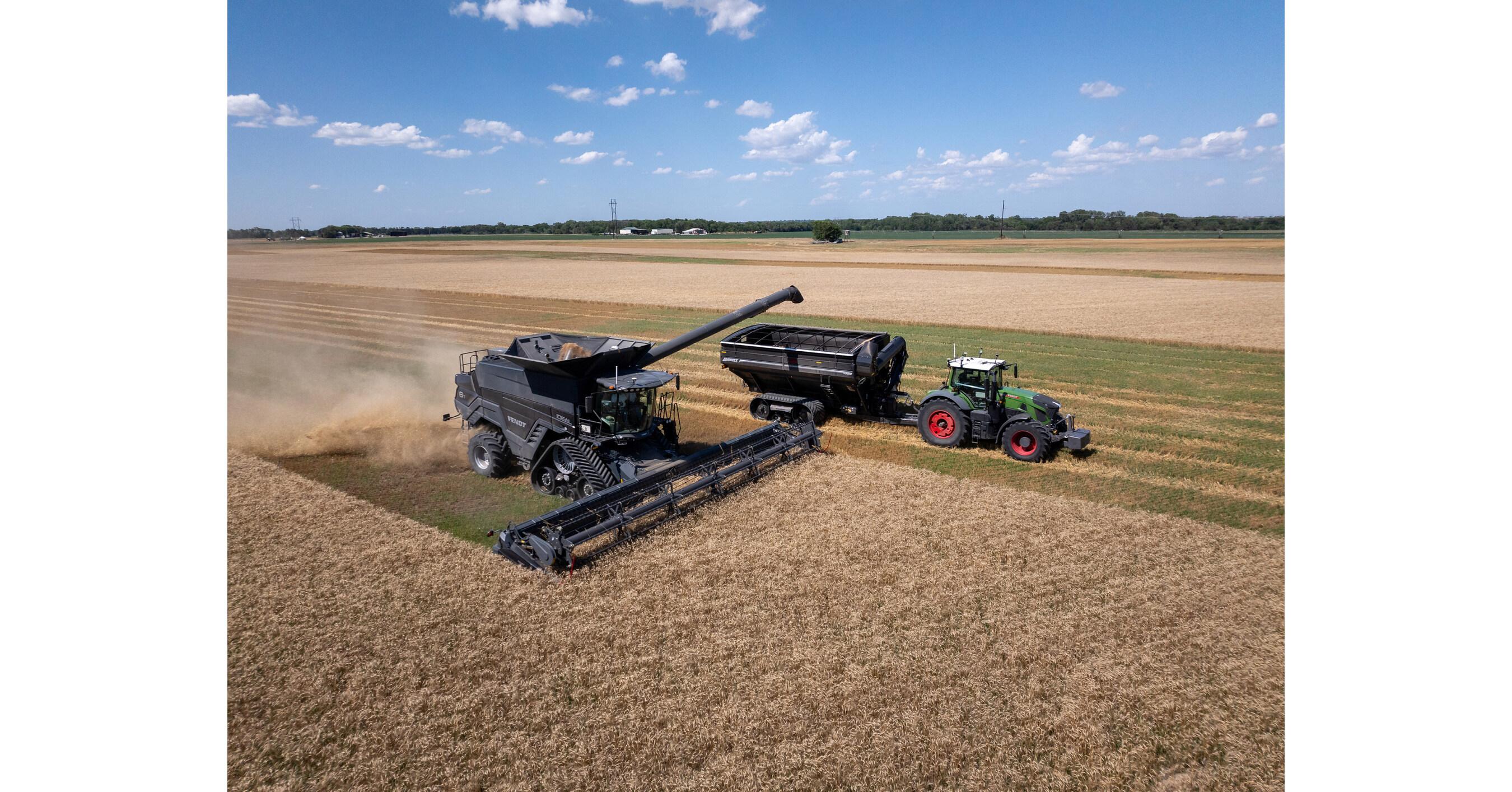 Real photograph of an AGCO Fendt tractor using autonomous grain-cart technology alongside a combine harvester in a wheat field.