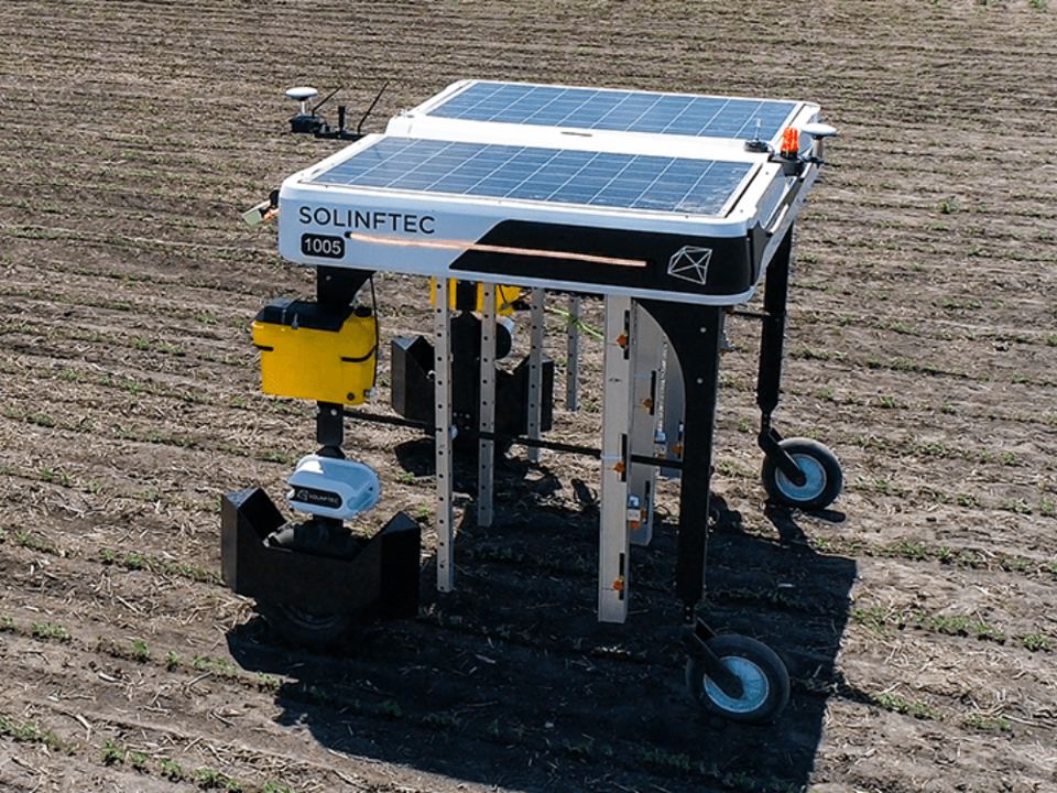 Solix Sprayer robot with roof-mounted solar panels in a field.