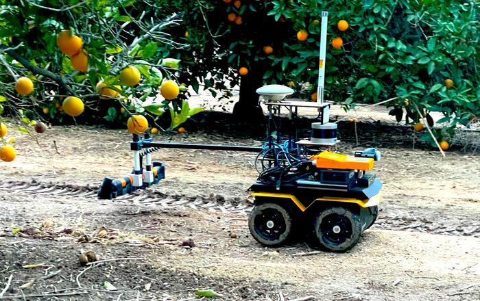 UC Riverside agricultural research robot measuring soil properties beneath citrus trees in an orchard.