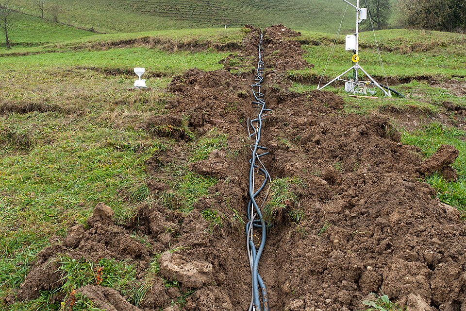 Cables and electrodes installed along a trench for electrical resistivity tomography monitoring