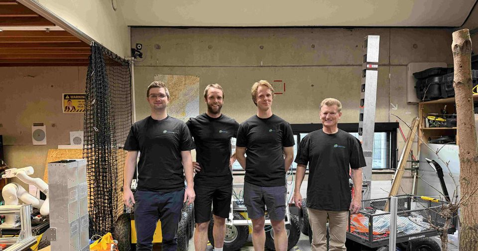 The UC Vision team with camera and robotic research equipment.