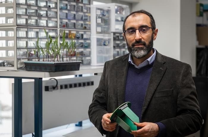 A Purdue researcher with experimental hardware for wireless subsoil monitoring.