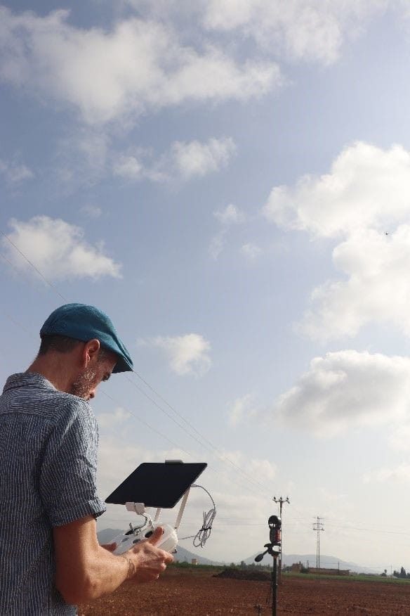 Drone operator using a controller during a field flight
