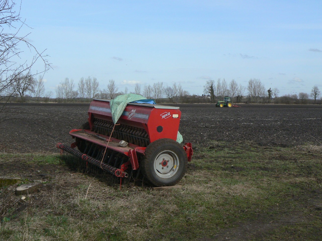 A Juko seed drill beside a cultivated field near Bunny, England.